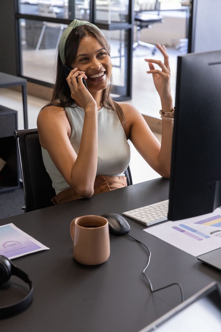 Businesswoman Communicating Via Smartphone in Modern Office Setup