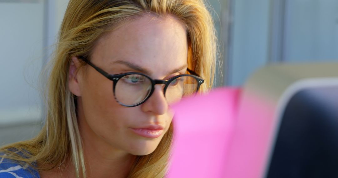 Focused Fashion Designer Analyzing Work on Computer