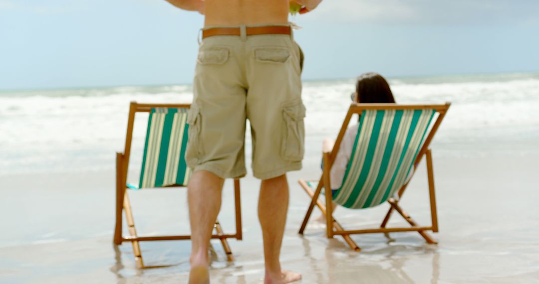 Couple Relaxing in Deckchairs by the Sea
