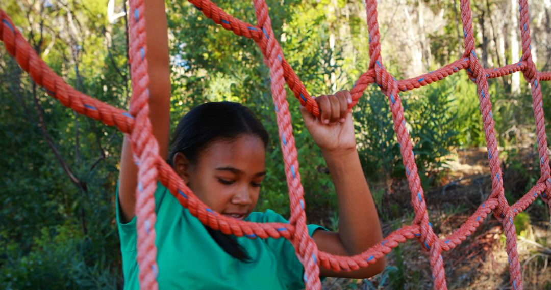 Young Girl Climbs Rope Net in Outdoor Adventure Park - Free Images, Stock Photos and Pictures on Pikwizard.com