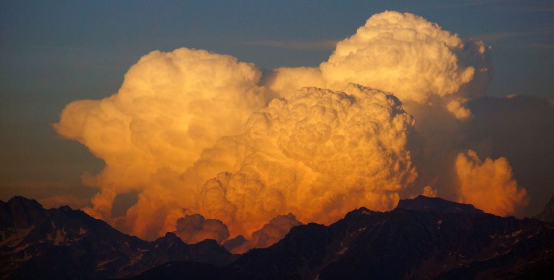 Dramatic Cumulonimbus Clouds Over Mountain Range at Sunset - Free Images, Stock Photos and Pictures on Pikwizard.com