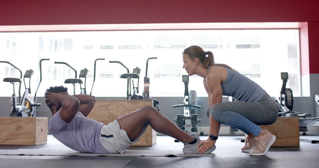 Personal Trainer Assisting Client During Gym Workout Session