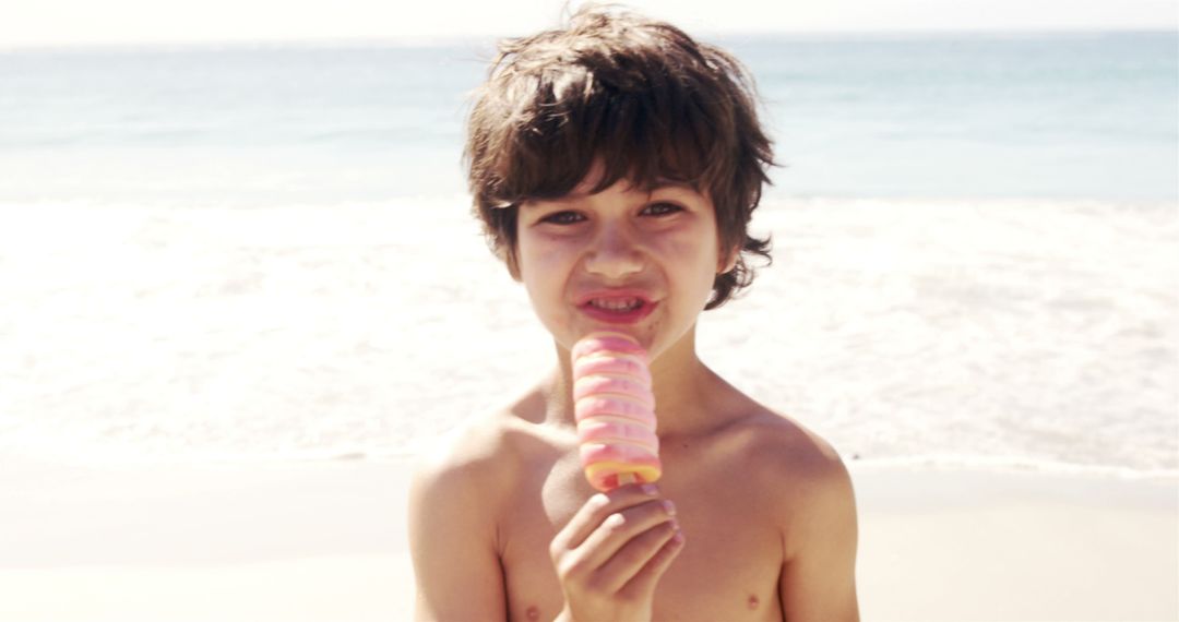 Young Boy Enjoying Ice Cream at Sunny Beach - Free Images, Stock Photos and Pictures on Pikwizard.com