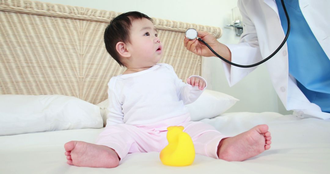 Doctor examining baby with stethoscope on bed - Free Images, Stock Photos and Pictures on Pikwizard.com