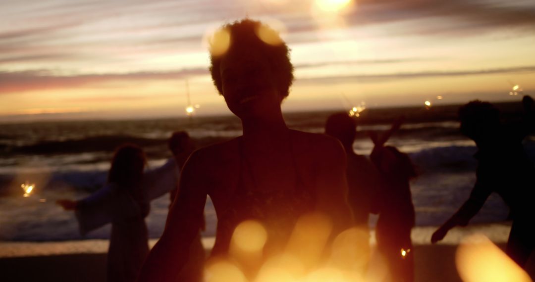 Silhouetted People Dancing on Beach at Sunset - Free Images, Stock Photos and Pictures on Pikwizard.com