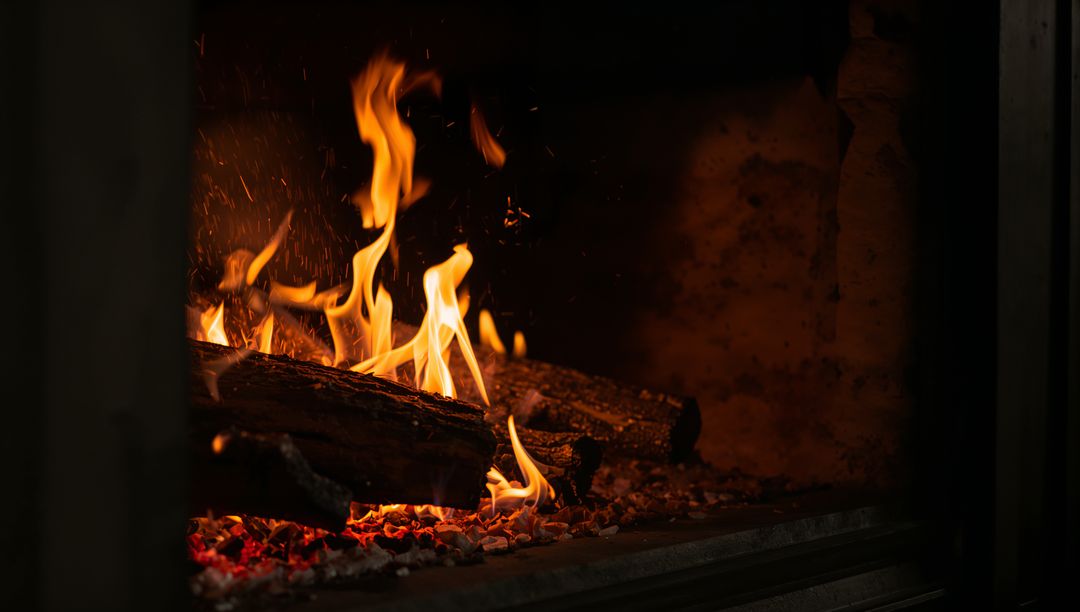 Crackling Fireplace with Glowing Embers and Dancing Flames on Charred Oak Logs