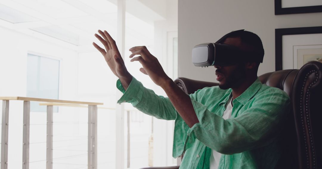 Man using virtual reality headset in modern home environment - Free Images, Stock Photos and Pictures on Pikwizard.com