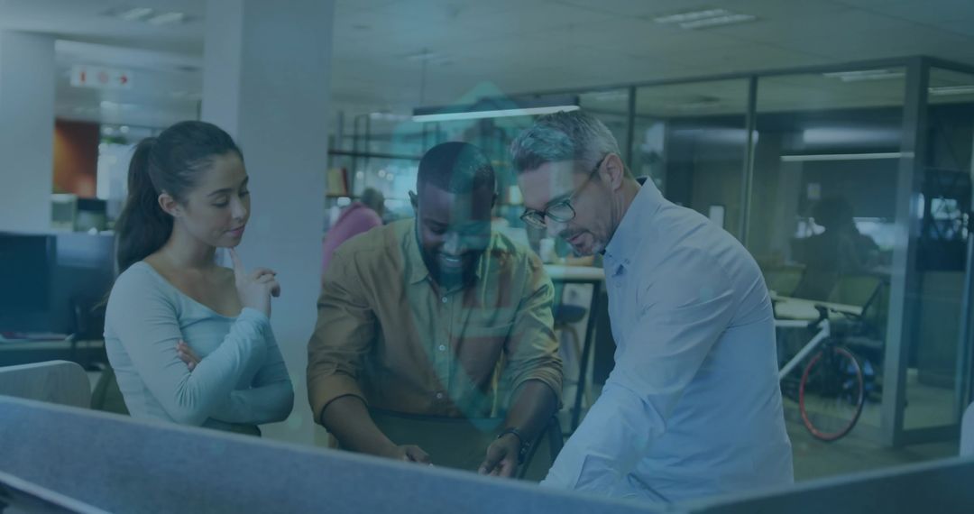 Team Collaborating Over Computer Screen in Modern Office Environment