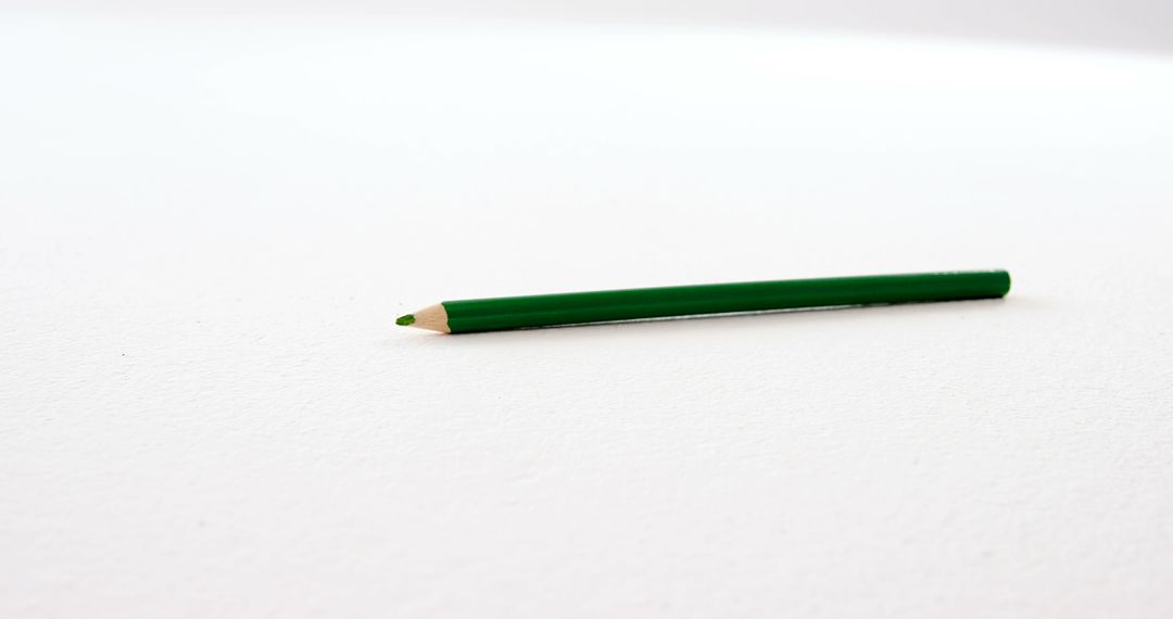 Green Pencil on White Surface Indicating Creativity - Free Images, Stock Photos and Pictures on Pikwizard.com