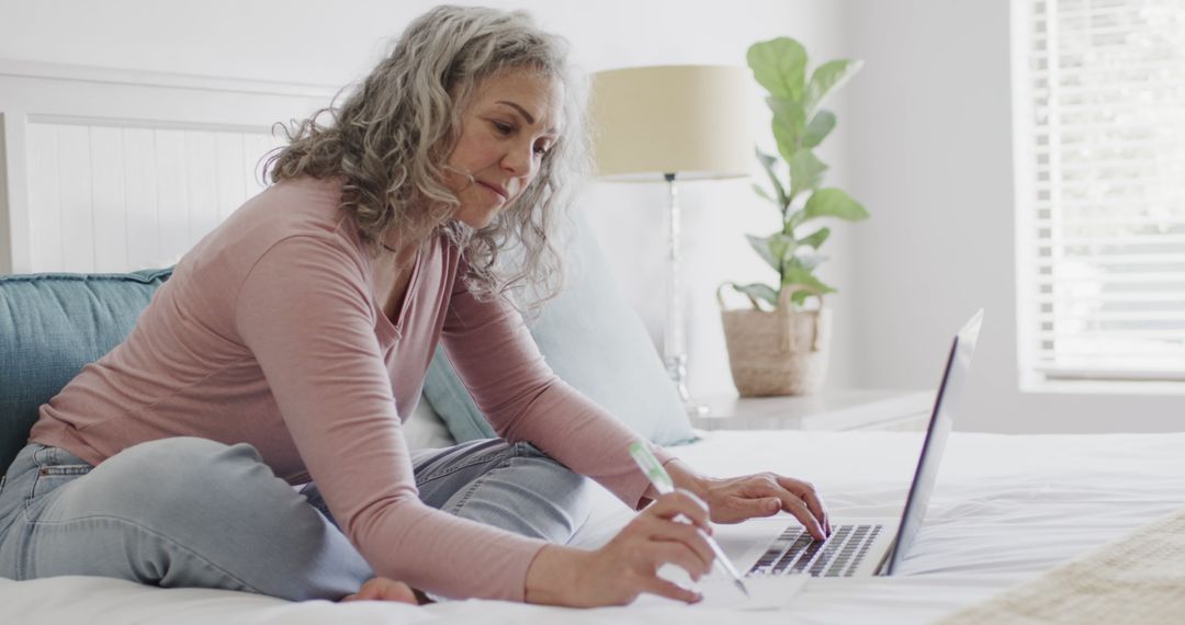 Mature Woman Working on Laptop from Home - Free Images, Stock Photos and Pictures on Pikwizard.com