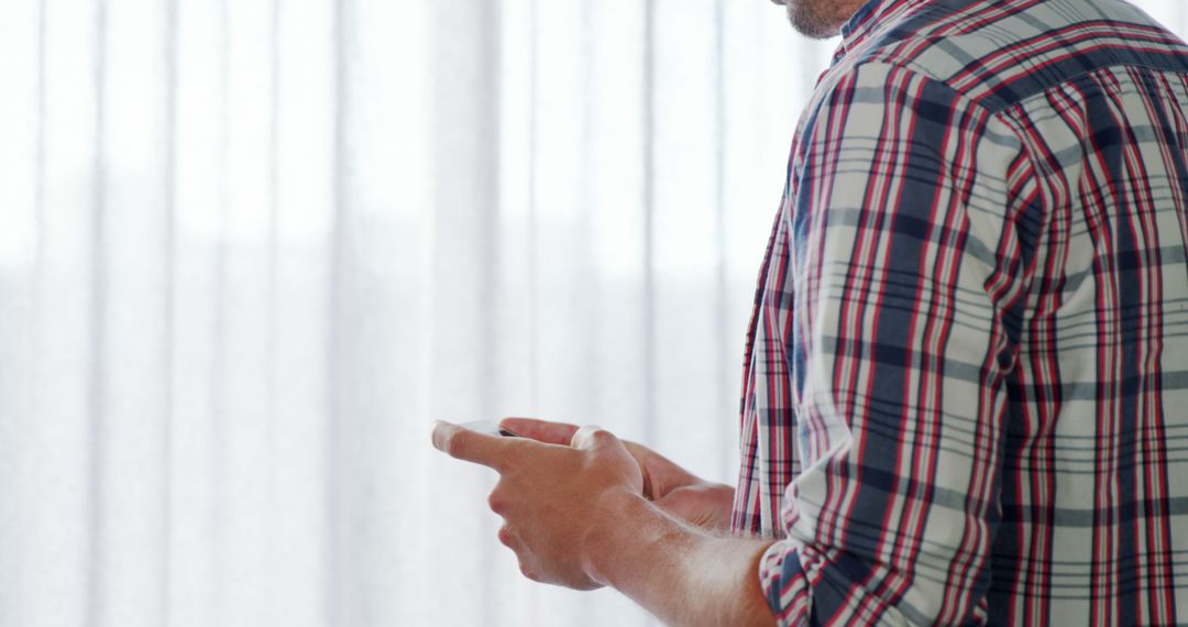 Casual Man Texting on Smartphone in Bright Room - Free Images, Stock Photos and Pictures on Pikwizard.com