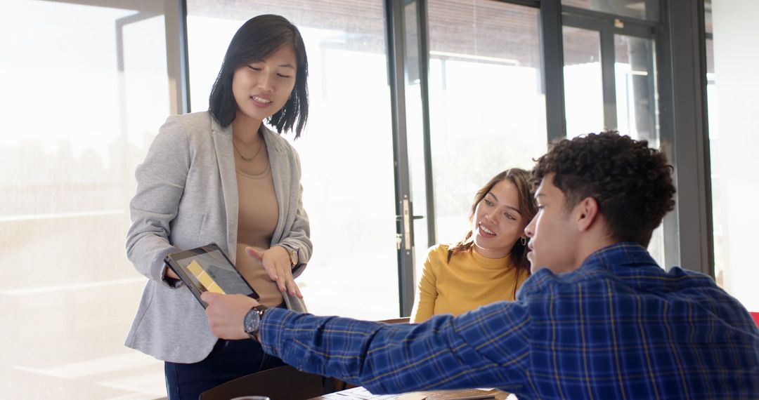 Diverse Team Collaborating with Tablet at Modern Office