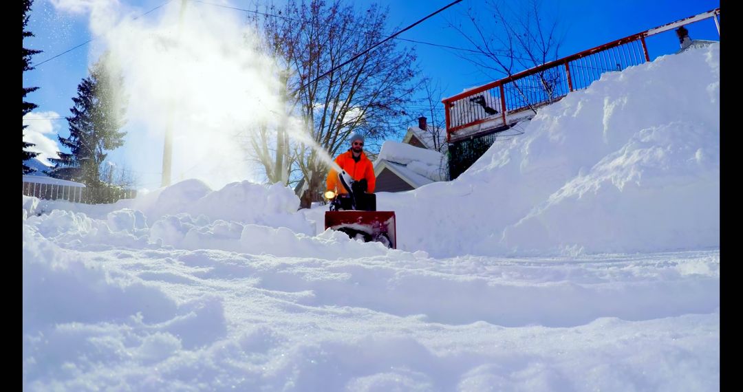 Man Clearing Snow Covered Yard with Snow Blower on Bright Winter Day - Free Images, Stock Photos and Pictures on Pikwizard.com