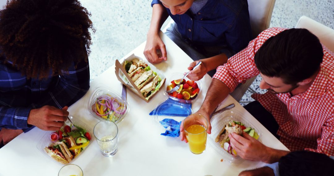 Diverse Team Enjoying Lunch Meeting at Office Table