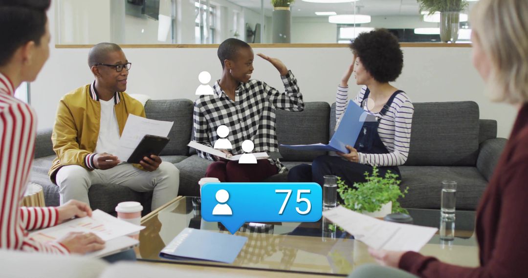 Diverse team collaborating in lounge with man in mustard jacket and follower count 75