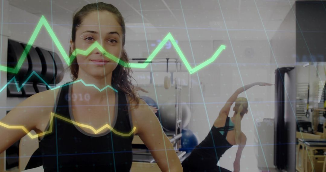 Confident Woman in Pilates Studio with Interactive Digital Graphs