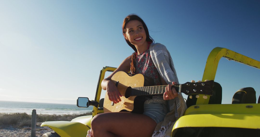 Young Woman Playing Guitar on Jeep At Beach Road Trip - Free Images, Stock Photos and Pictures on Pikwizard.com