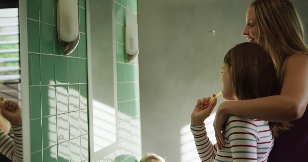 Mother Helping Daughter Brush Teeth in Bathroom - Free Images, Stock Photos and Pictures on Pikwizard.com