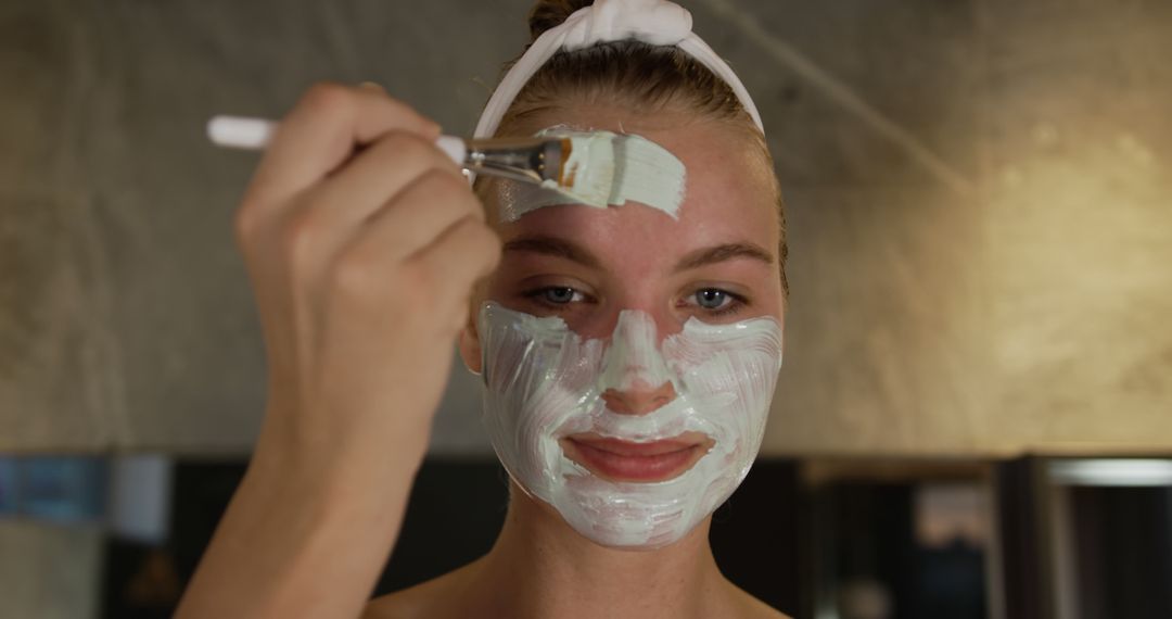 Woman Applying Face Mask with Brush in Spa - Free Images, Stock Photos and Pictures on Pikwizard.com