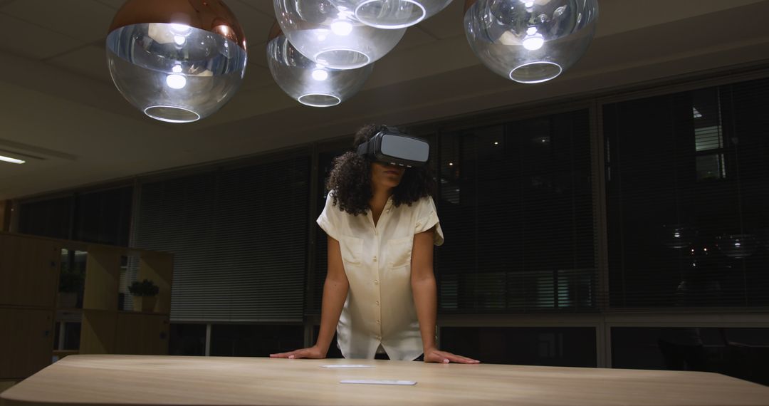 Woman Experiencing Virtual Reality in Modern Office at Night - Free Images, Stock Photos and Pictures on Pikwizard.com