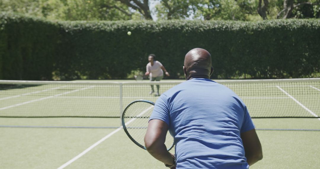 Two People Playing Tennis on Sunny Day - Free Images, Stock Photos and Pictures on Pikwizard.com