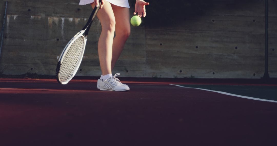 Female athlete preparing to serve tennis ball on court - Free Images, Stock Photos and Pictures on Pikwizard.com