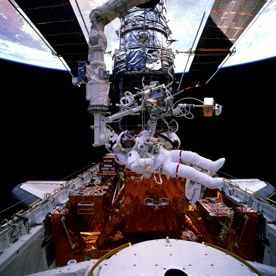 Astronaut Performing Spacewalk Near Hubble Space Telescope - Free Images, Stock Photos and Pictures on Pikwizard.com
