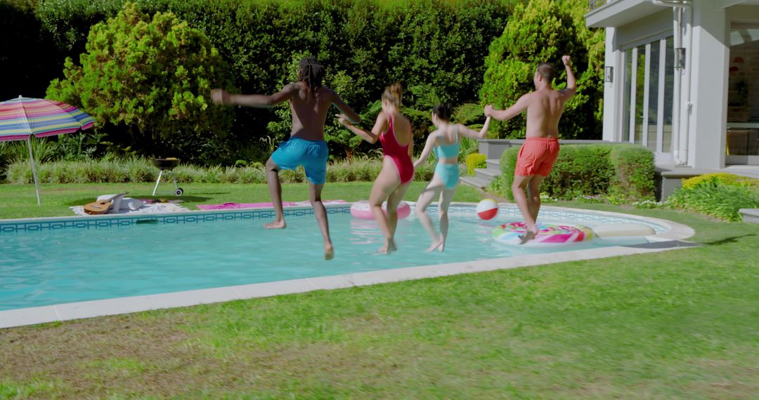 Diverse Friends Laughing and Splashing in Backyard Pool Party