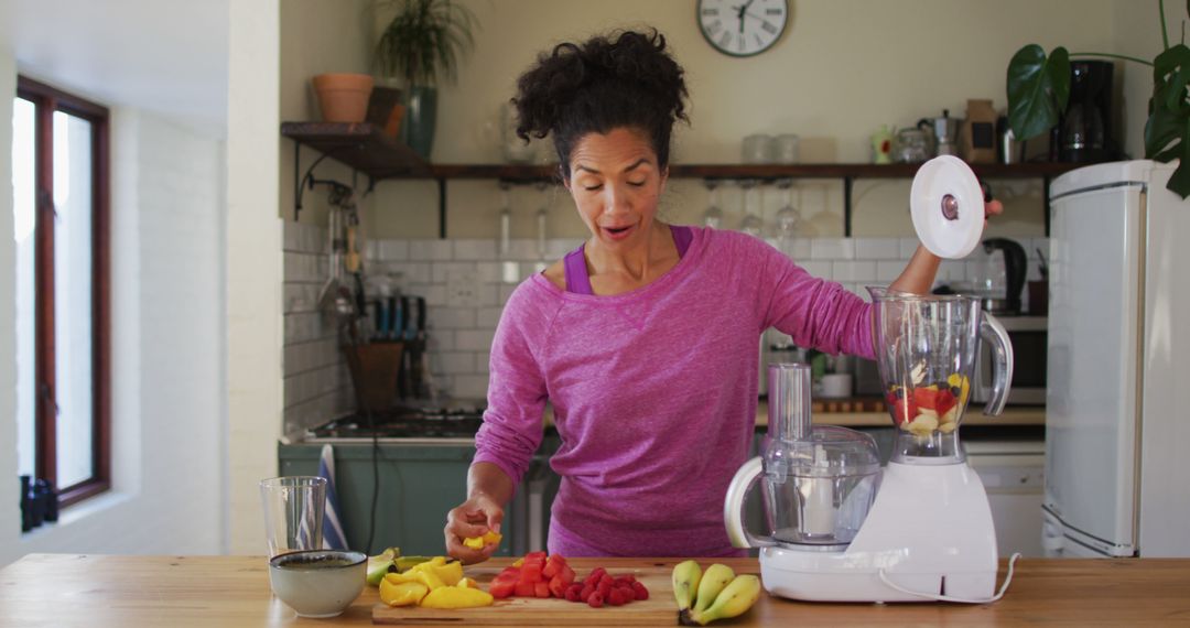 Woman Creating Fruit Smoothie in Modern Kitchen - Free Images, Stock Photos and Pictures on Pikwizard.com