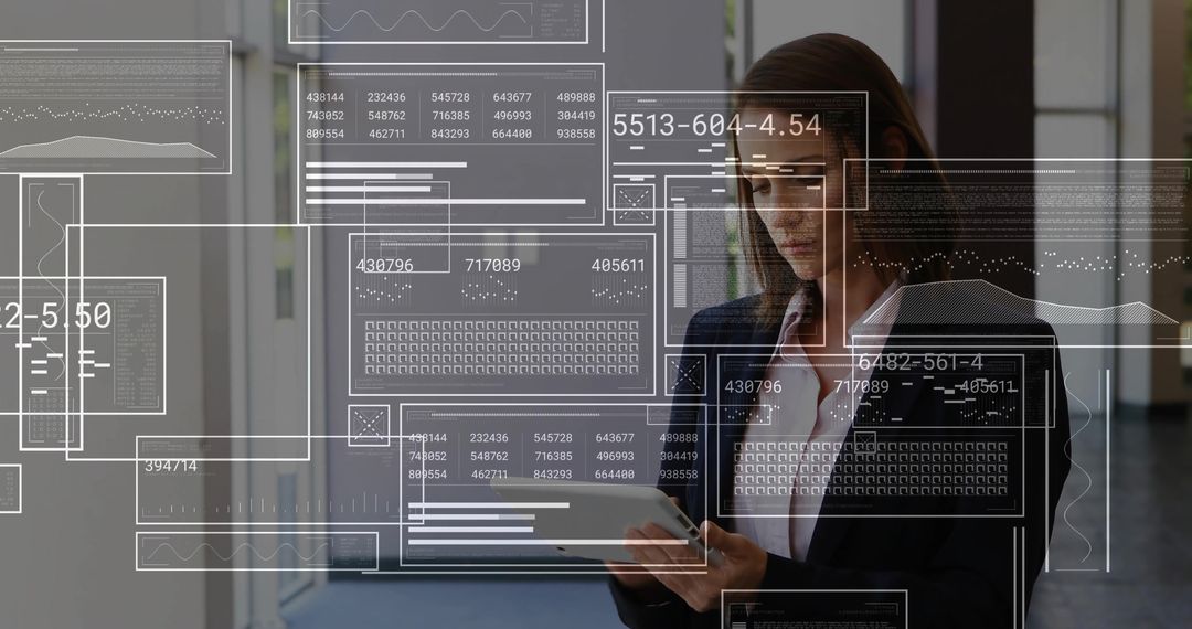 Mid-adult businesswoman using tablet with augmented reality data dashboards in office