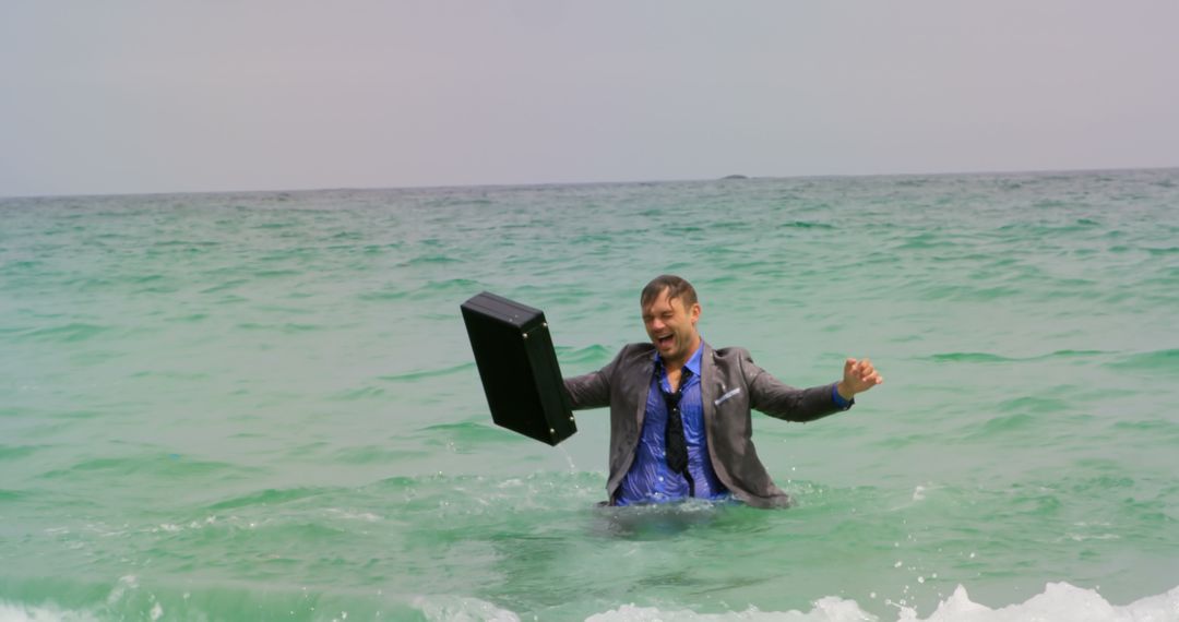 Joyful Businessman Dancing in Ocean with Briefcase