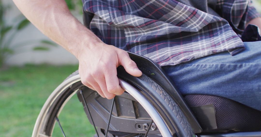 Close-up of Man Operating Wheelchair Outdoors - Free Images, Stock Photos and Pictures on Pikwizard.com