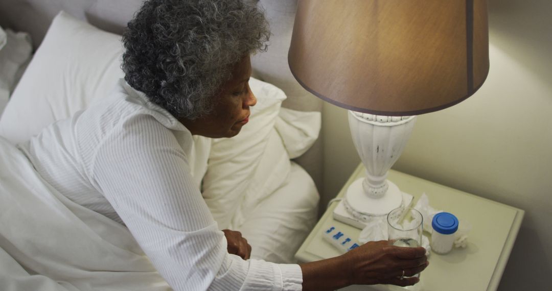 Elderly Woman Reaching for Medication on Nightstand - Free Images, Stock Photos and Pictures on Pikwizard.com