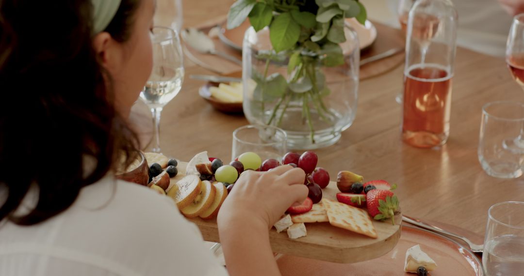 Elegant Dining Experience with Bountiful Fresh Fruit Platter and Wine