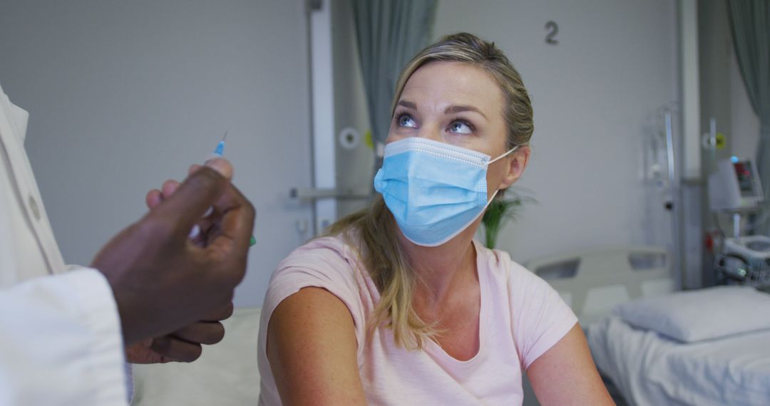 Woman Receiving Vaccination in Hospital Room - Free Images, Stock Photos and Pictures on Pikwizard.com