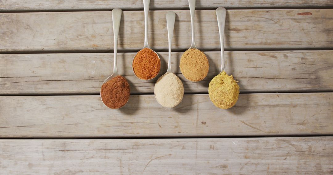 Various Spices in Spoons on Wooden Table - Free Images, Stock Photos and Pictures on Pikwizard.com