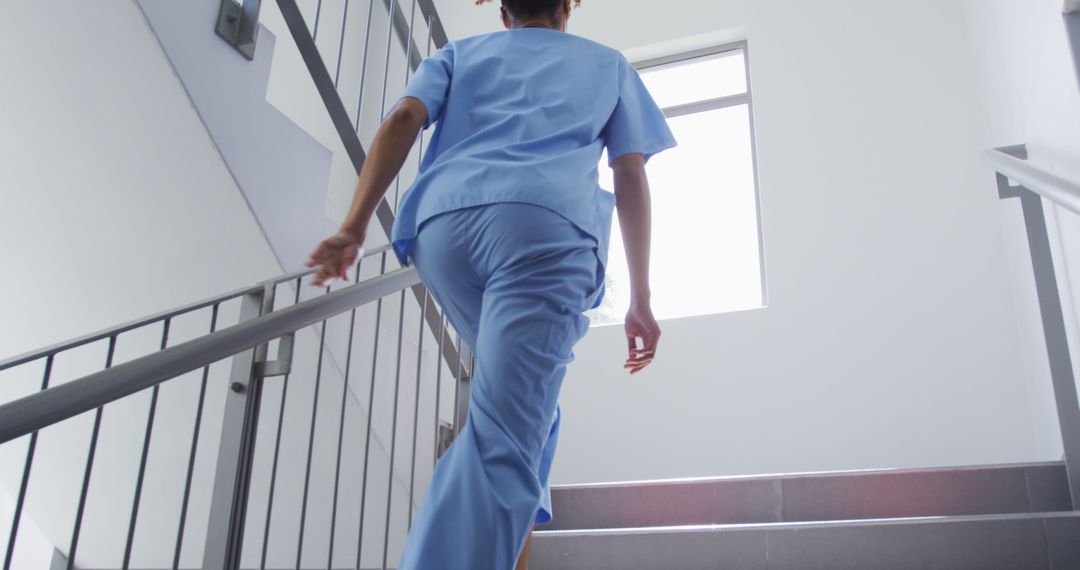 Nurse Climbing Stairs in Hospital Building - Free Images, Stock Photos and Pictures on Pikwizard.com