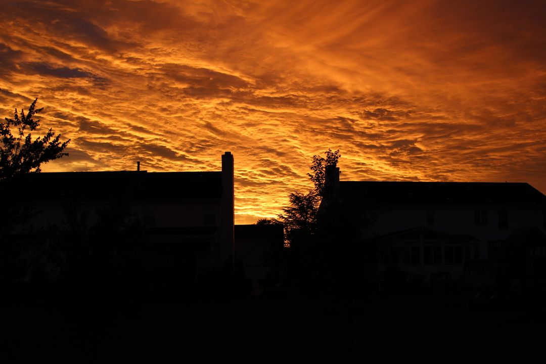 Dramatic Sunset Sky with Silhouetted Houses and Trees - Free Images, Stock Photos and Pictures on Pikwizard.com