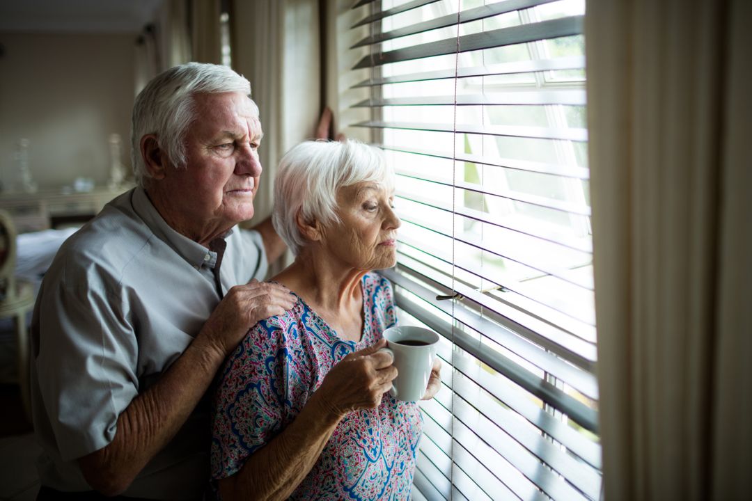 Senior Couple Looking Out Window at Home - Free Images, Stock Photos and Pictures on Pikwizard.com