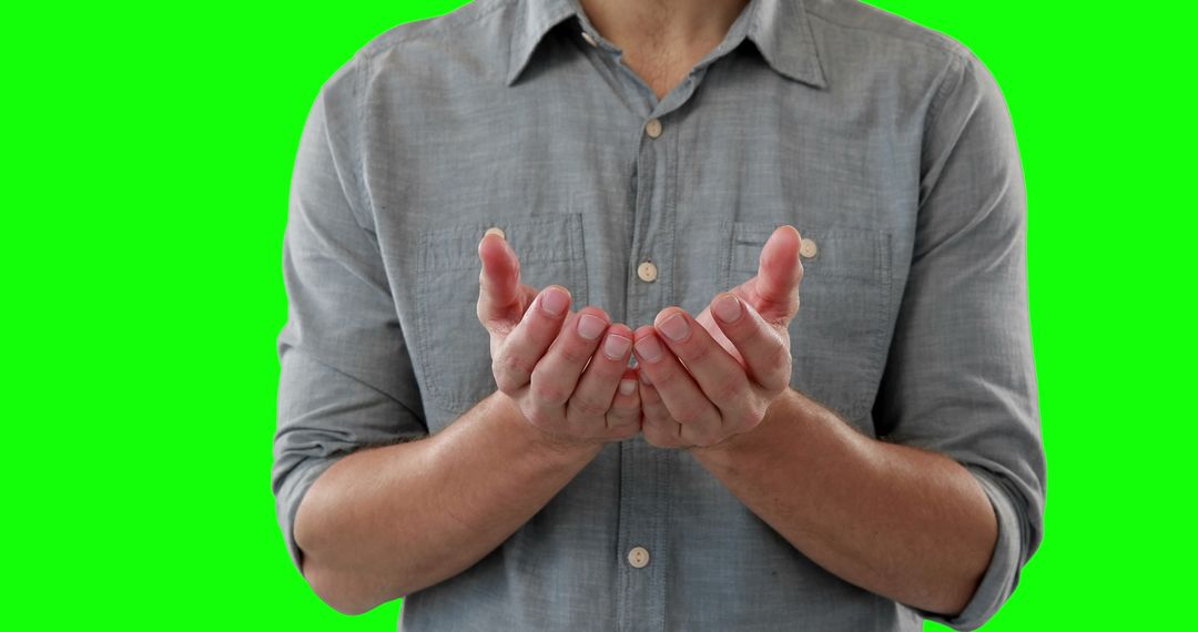 Man's cupped hands in front of green background - Free Images, Stock Photos and Pictures on Pikwizard.com