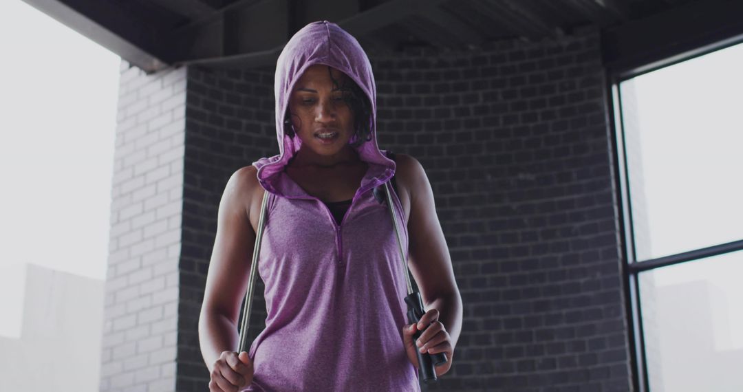 Athletic Woman Persevering with Jump Rope Exercise Indoors