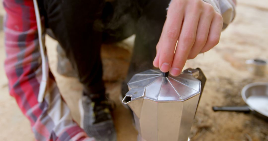 Person Preparing Coffee Outdoors with Moka Pot Close-Up - Free Images, Stock Photos and Pictures on Pikwizard.com