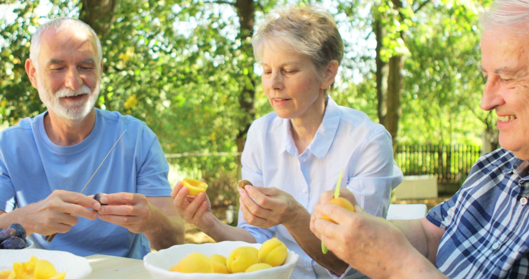 Seniors Enjoying Outdoor Activity of Fruit Preparation Together - Free Images, Stock Photos and Pictures on Pikwizard.com