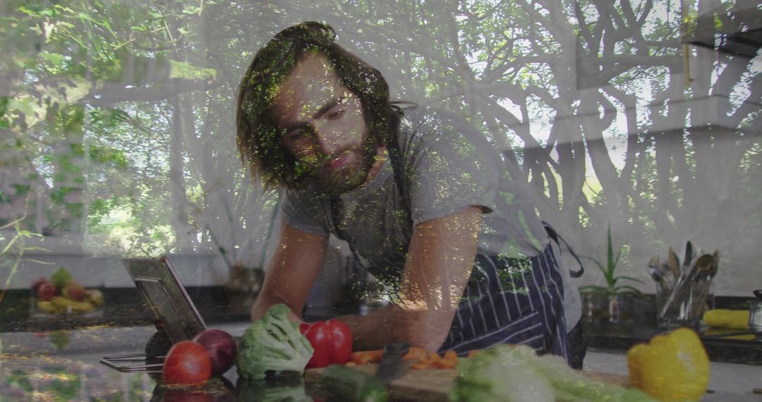 Chef Chopping Fresh Vegetables in Modern Kitchen with Tablet