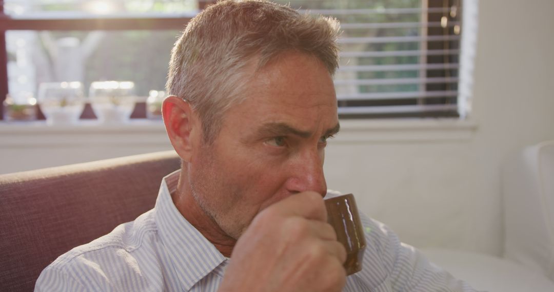 Mature Man Drinking Coffee in Relaxing Home Interior - Free Images, Stock Photos and Pictures on Pikwizard.com