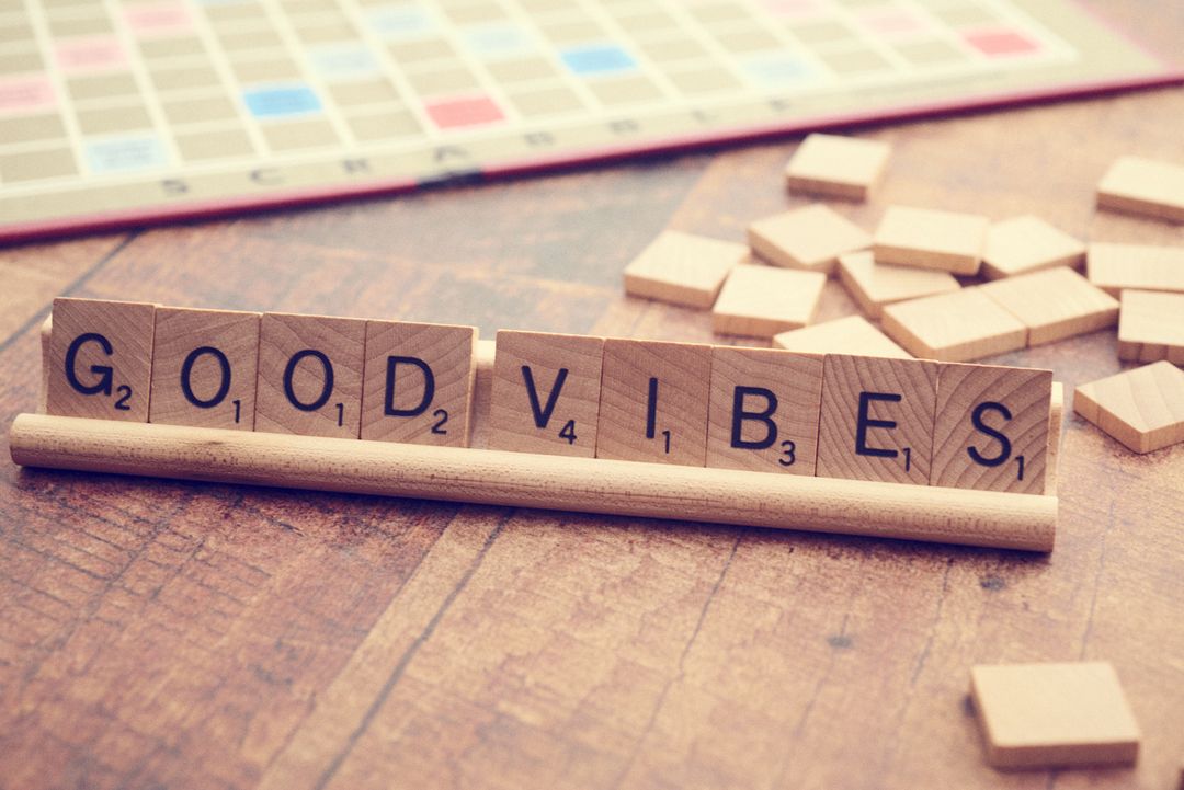 Inspirational Message with Scrabble Tiles on Wooden Surface