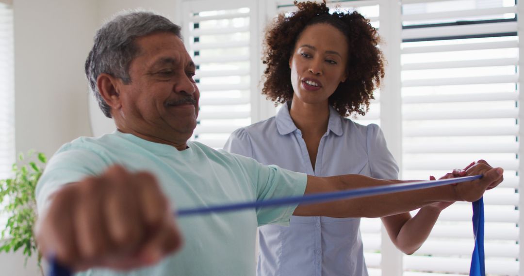 Elderly Man Exercising with Resistance Band Assisted by Physical Therapist - Free Images, Stock Photos and Pictures on Pikwizard.com