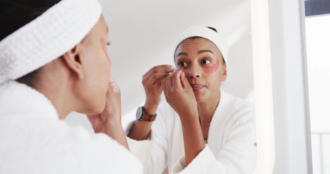 Woman Applying Under-Eye Patches in Bathroom Mirror - Free Images, Stock Photos and Pictures on Pikwizard.com