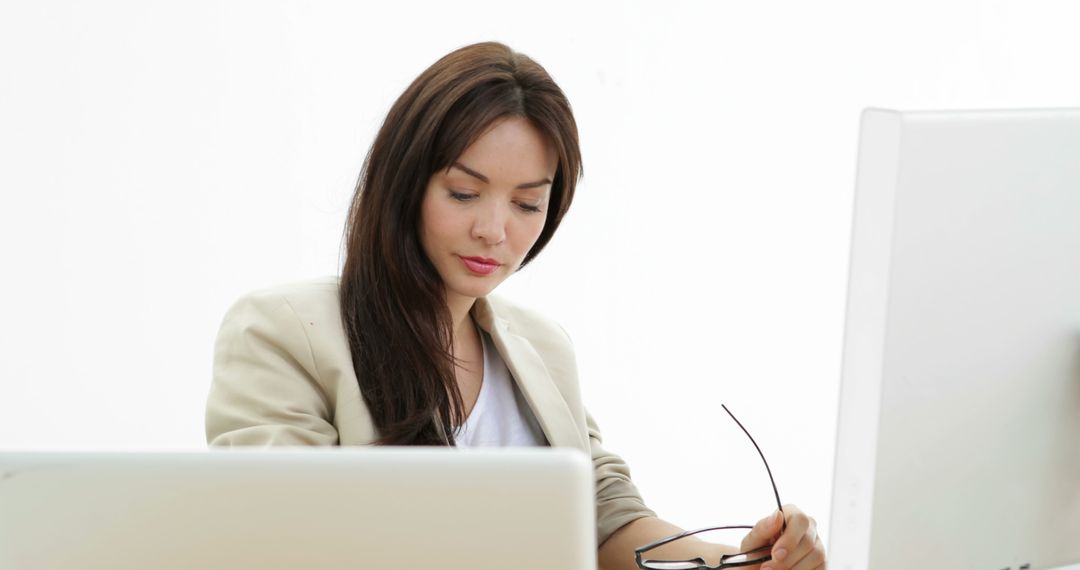 Professional Woman Managing Work with Multiple Devices
