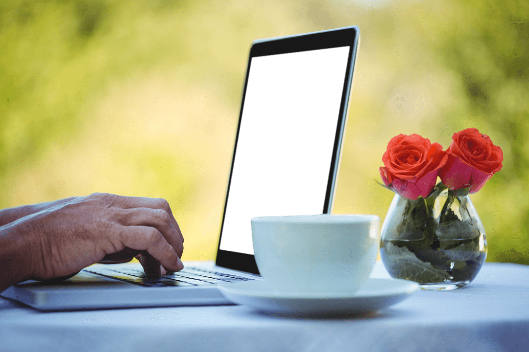 Transparent Laptop Screen on Outdoor Table with Flowers and Coffee